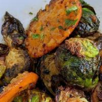 Fried Brussels with Pixie Mandarin · Incredible

Dressed with date molasses, apple cider vinegar, garlic, cardamom, and Urfa Bibb...
