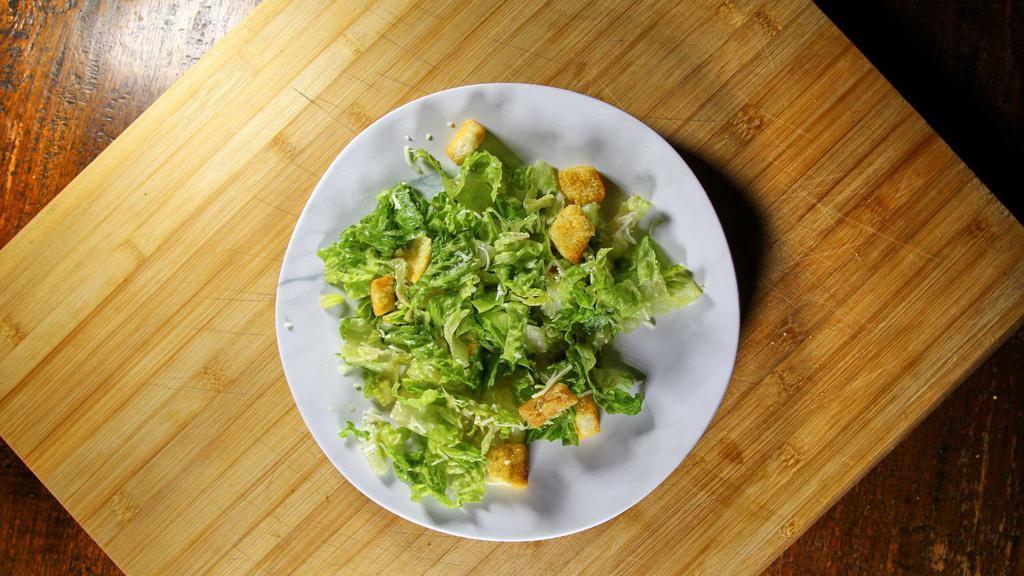Caesar Salad · Romaine hearts, garlic croutons, classic caesar dressing topped with shaved Parmigiano-Reggiano.
