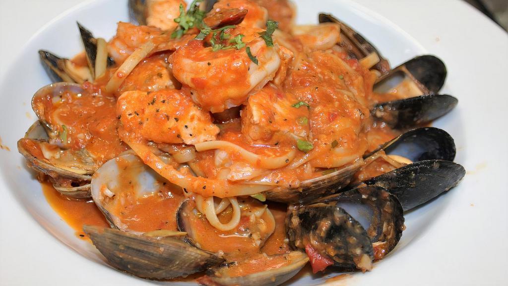 Frutti di Mare · Linguini pasta served with pan seared prawns, scallops, mussels, rock shrimp, manila clams and with fresh seasonal fish, and spicy marinara sauce.