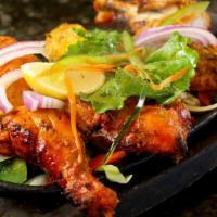 Chicken Tandoori · Chicken on the bone marinated in yogurt, ginger and freshly ground spices. Skewered and gril...