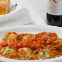 Ravioli Napolitano · Ravioli stuffed with spinach, ricotta in pummarola tomato sauce.