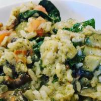 Risotto Ortolano · Arborio rice with fresh vegetables in a light pesto sauce.