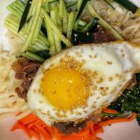 Bi Bim Bab (L) · Steamed rice topped with vegetables, meat & egg.