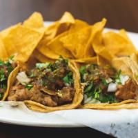 Taco Plate · Two taco's with choice of meat, onions, cilantro, hot salsa, served with choice of beans and...