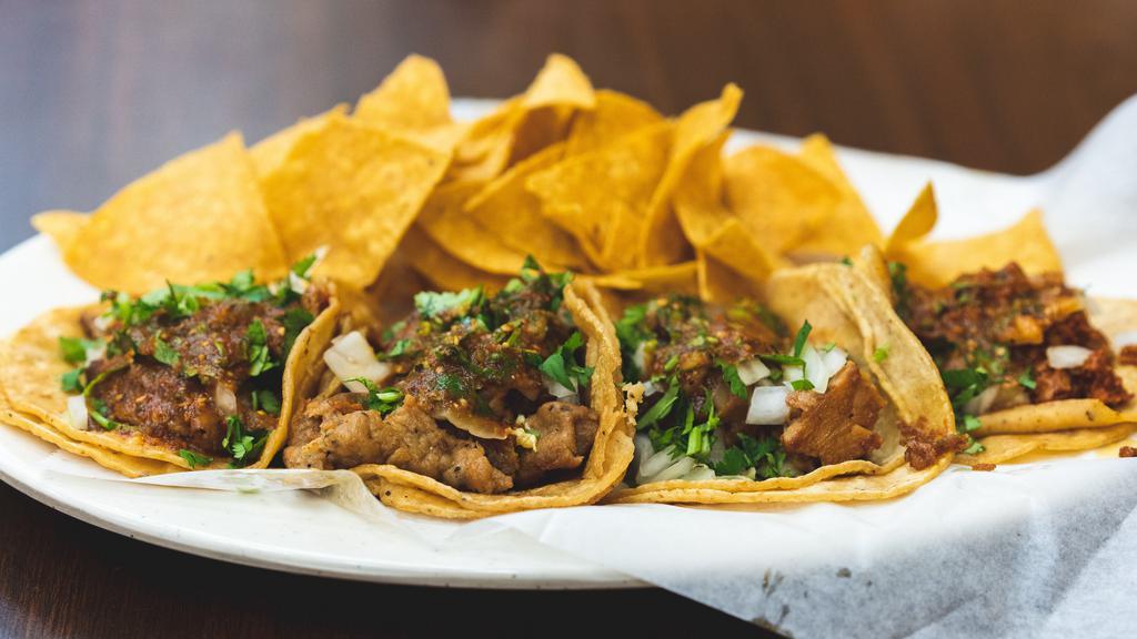 Taco Plate · Two taco's with choice of meat, onions, cilantro, hot salsa, served with choice of beans and rice.
