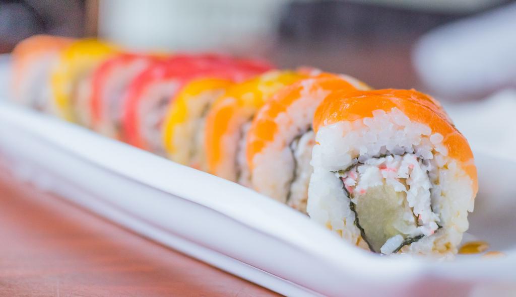 Tropical Paradise Roll · crab meat and pineapple topped with mango, tuna, salmon and chef's special sauce