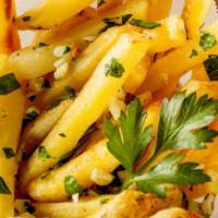 Garlic Fries · Crispy golden french fries smothered in galic and cilantro