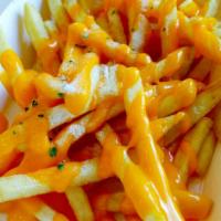 Cheesy Fries · Crispy golden french fries smothered in hot creamy cheese with spicy sauce