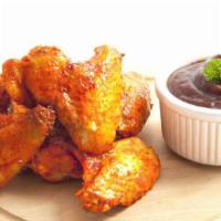Bbq Chicken Wings · Chicken wings deep fried to perfection and smothered in BBQ sauce. Served with celery, carro...
