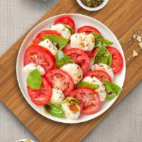 Caprese Breeze Salad · Fresh Mozzarella, tomato, and basil topped with extra virgin olive oil.