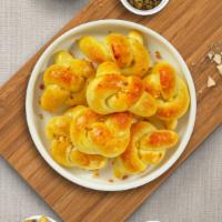 Gimme Garlic Knots · Fresh pizza dough tied into knots, tossed with garlic, olive oil, and parsley. Served with a...