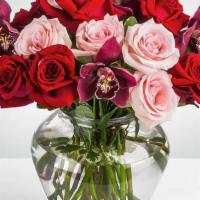 Truly Adored · This arrangement includes purple cymbidium orchids, red roses, & pink roses. Truly Adored  i...