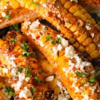 Mexican Street Corn Ribs · Corn ribs served in our delicious elote asado sauce topped with tajin and queso.