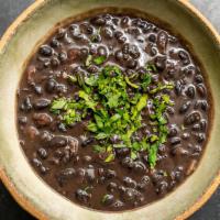 Black Beans  · Organic black beans with  cilantro, lime topped with queso.