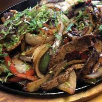 Steak Fajitas · Steak, bell peppers, onions, rice & beans