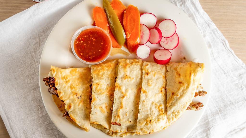 Quesadilla · Hand made tortilla filled with cheese and your choice of meat.