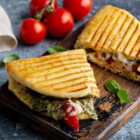 Turkey Avocado Panini · Hot off the panini press! Comes with turkey, avocado, roasted peppers, spinach, mayonaise, a...