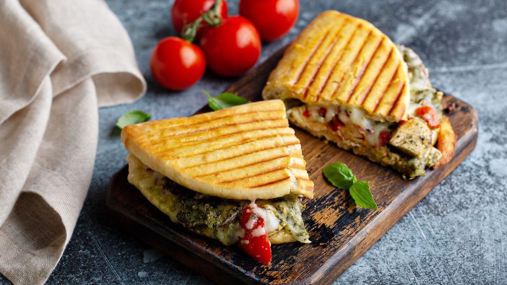 Grilled Chicken Panini · Hot off the panini press! Comes with grilled chicken breast, chopped lettuce, onions, tomatoes, mozzarella cheese, mustard and mayo.