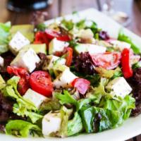 Mediterranean Salad · Romaine hearts, tomatoes, cucumbers, feta cheese, shaved carrots, and red cabbage Served wit...