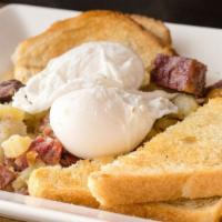 Tom Boy · Poached eggs, potato, apple and parsnip corned beef hash, acme white toast.
