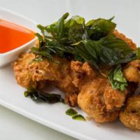 Chicken Wings · Fried chicken wings glazed with sweet * sour ginger
sauce, topped with crispy Thai basil lea...