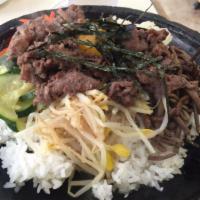 BBQ Beef & Vegetables in Stoneware · Rice, BBQ beef, and vegetables served in stoneware with an assortment of kimchi dishes