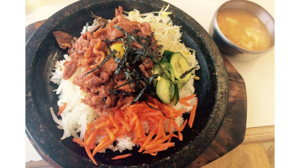 BBQ Pork & Vegetables in Stoneware · Rice, BBQ sliced spicy pork, and vegetables served in stoneware with an assortment of kimchi dishes.
