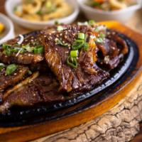 Beef Short Ribs · Beef short ribs served with rice and an assortment of kimchi dishes.