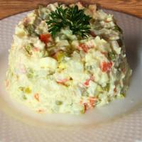 Olivie · Russian style potato salad: chicken, potato, boiled eggs, pickles, sweet peas and mayonnaise.