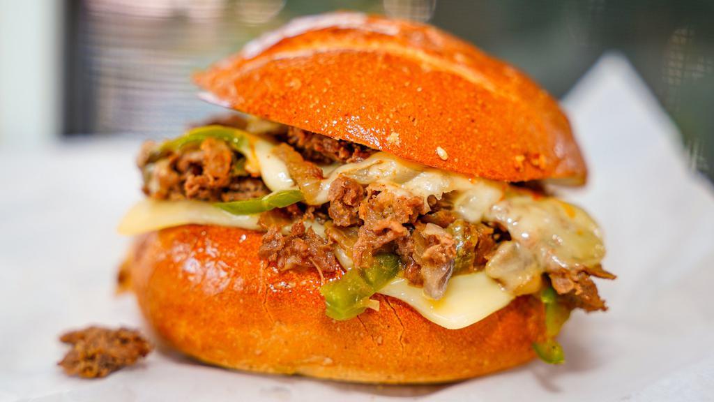Cheesesteak · Chopped, thinly sliced steak on a french roll with mayo, cheese, sautéed onion, and bell pepper.
