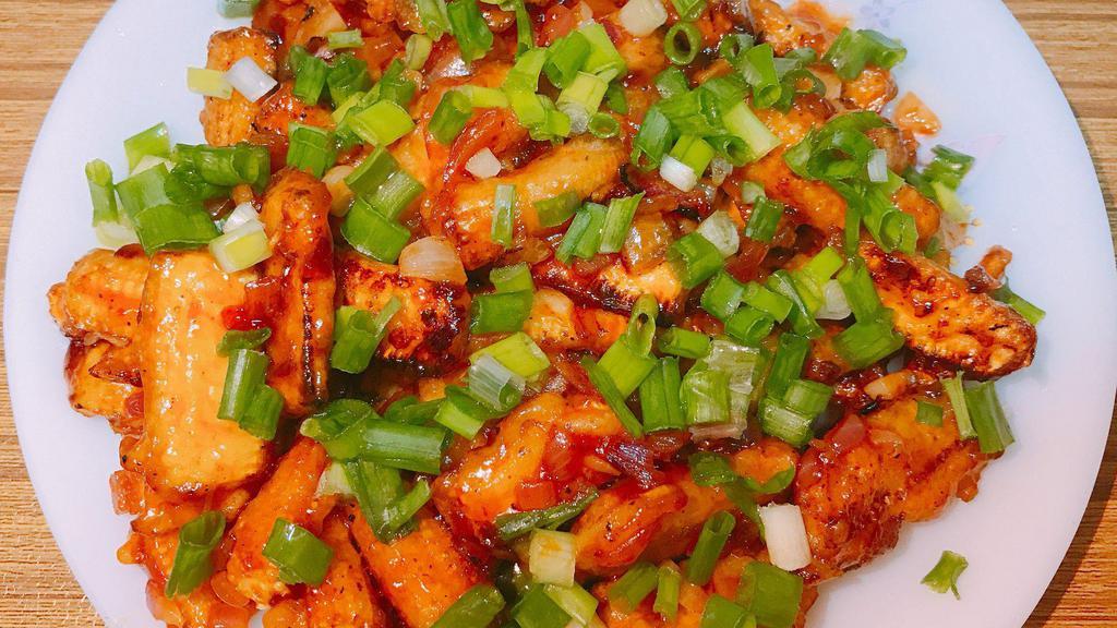 Baby Corn Manchuria · Batter fried baby corn pieces tossed and coated in tangy garlic sauce.