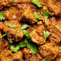 Nizami Goat Curry · Special goat curry cooked on slow fire with fresh spices and roasted onion sauce.