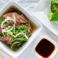 13. Brisket Phở (L) · Beef Pho served topped with Brisket