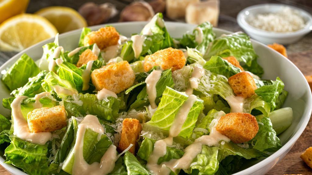 Caesar Salad · Romaine lettuce tossed with parmesan cheese, seasoned croutons and Caesar dressing.