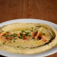 Classic Hummus · Gluten free. Chickpeas, imported tahini, lemon juice, garlic, spices. Served with pita bread.