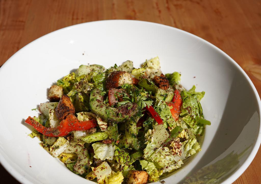 Fattoush Salad · Lebanese salad of romaine hearts, cucumbers, tomatoes, onions, bell peppers, parsley, sumac, croutons and extra virgin olive oil.
