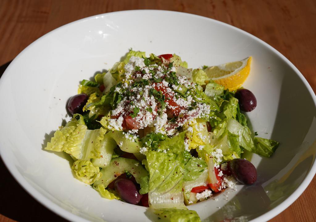 Greek Salad · Hearts of romaine, tomato, Kalamata olives, cucumber, red onion, bell pepper, feta cheese, and lemon olive oil dressing.