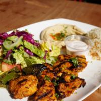 Chicken Souvlaki Plate · Herbed marinated chicken breast cubes. Served with rice, salad, hummus and pita.