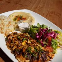Chicken Gyros Plate · Slow cooked, thinly sliced, marinated chicken. Served with rice, salad, hummus and pita.