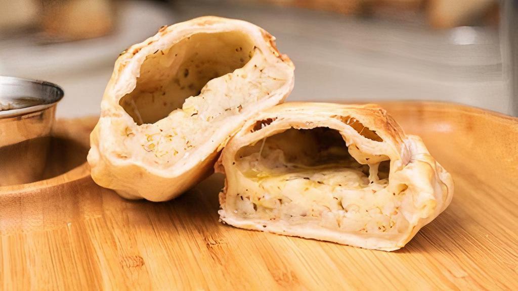 Fugazzetta (Onions) Empanada · Caramelized red and white onions, a blend of Mozzarella and Paremesan cheese, oregano and other herbs