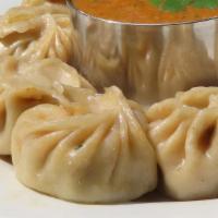 Chicken Momo · Famous Nepalese style steamed chicken dumpling served with tomato and sesame chutney.