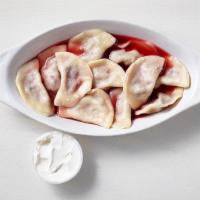 Cherry Vareniki · Russian style dumplings with sour cherries inside, served in a rich cherry syrup and sour cr...