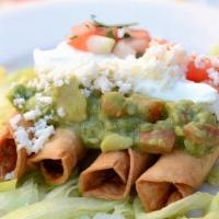 Taquitos · Five crispy rolled corn tortillas. Served on a bed of lettuce with your choice of shredded b...