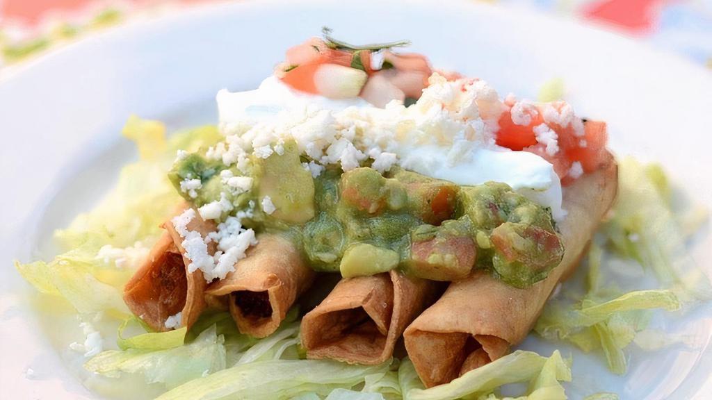 Taquitos · Five crispy rolled corn tortillas. Served on a bed of lettuce with your choice of shredded beef or chicken. Topped with crema, guacamole, and pico.