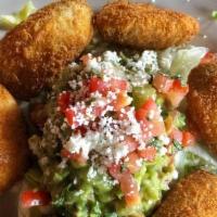 Jalapeñitos · Six bite-sized jalapeño poppers filled with cream cheese, lightly breaded, and crispy. Serve...