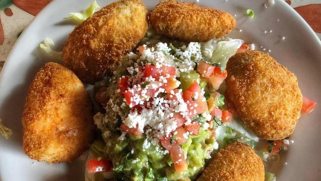 Jalapeñitos · Six bite-sized jalapeño poppers filled with cream cheese, lightly breaded, and crispy. Served with guacamole, pico de gallo, and queso fresco.
