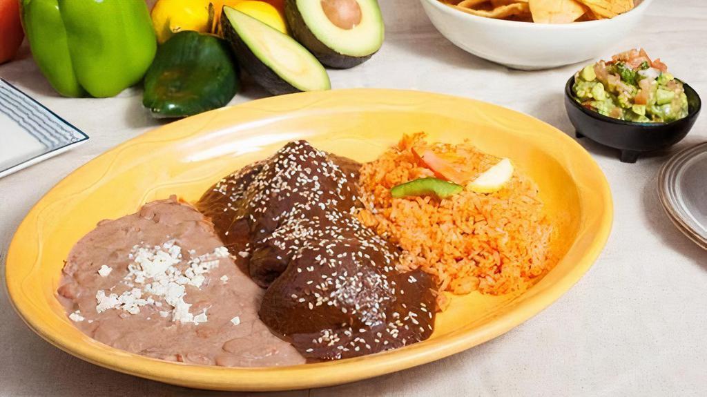 Molé Poblano · Boneless, skinless chicken with our own special mole poblano made from scratch. We use over 30 ingredients including Mexican chocolate, dry, and roasted chiles to produce a wonderfully complex sauce. Rice and refried beans.