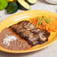 Enchiladas de Mole · Two corn tortillas with shredded chicken. Topped with our delicious mole sauce and cheese. S...