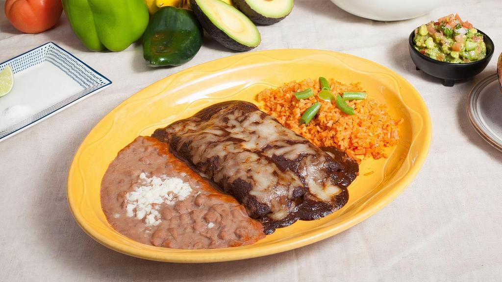 Enchiladas de Mole · Two corn tortillas with shredded chicken. Topped with our delicious mole sauce and cheese. Serve with rice and refried beans.