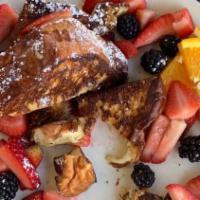 Buttery Vanilla Orange French Toast · Maple Syrup, Caramelized Bananas, Strawberry & Blackberries for an additional charge.